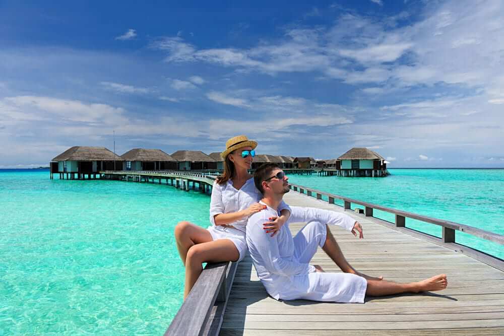 Maldives vs Sri Lanka: Which Holiday is Right for You? 1 Couple relaxing by overwater villas